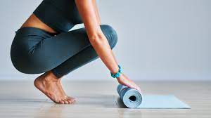 Pilates instructor with mat