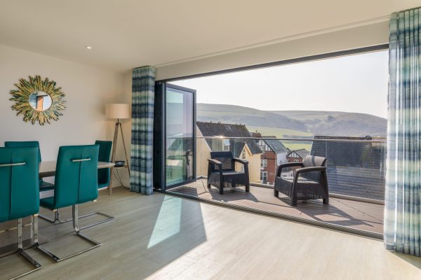 Open plan living room, balcony doors open