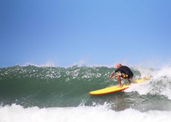 A surfer riding a wave off the coast of North Devon