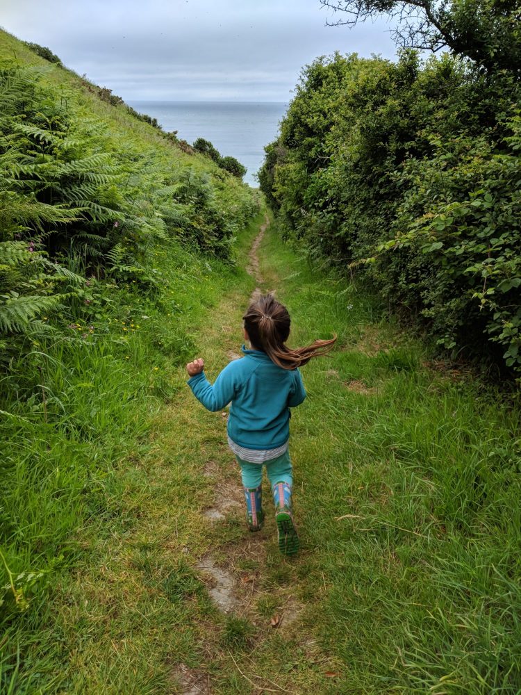 Child walking toward Rockham Bay