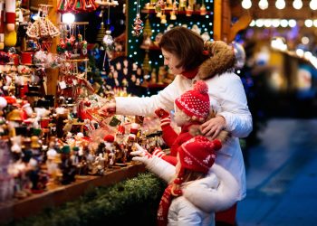Family visiting North Devon Christmas market during a Christmas getaway
